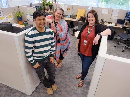 Two women and a man in an office building