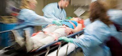 Health care team treating patient on stretcher