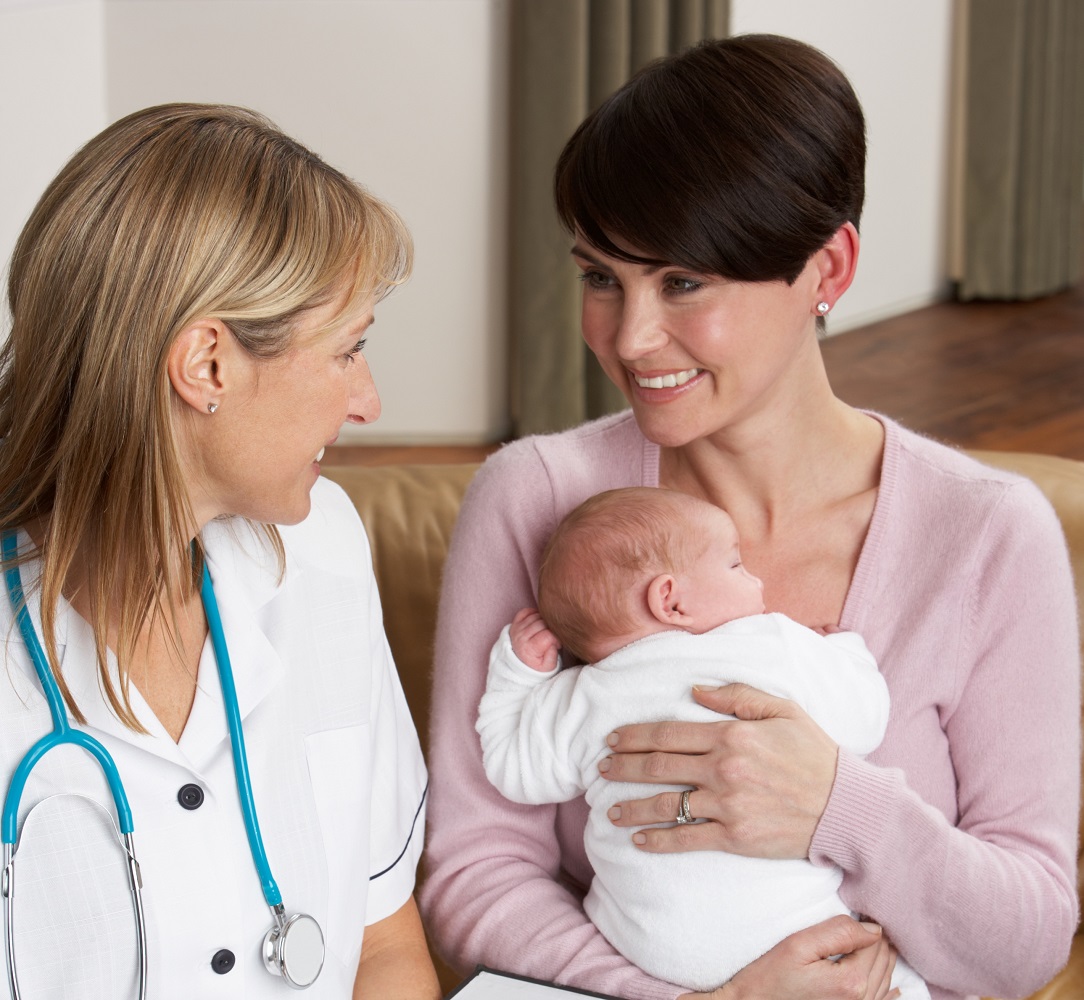 Midwife with mother and baby