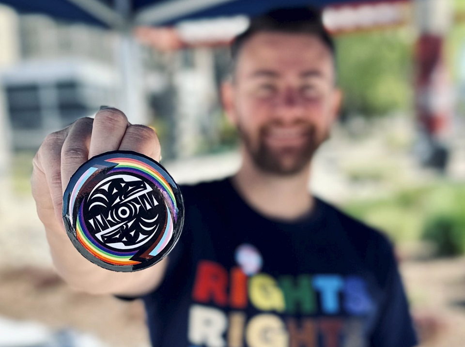 Man holds Indigenous-designed Pride whorl