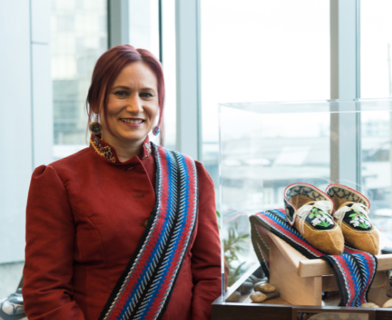 Portrait of Lisa Shepherd and her artwork, which features Metis moccasins and sashes