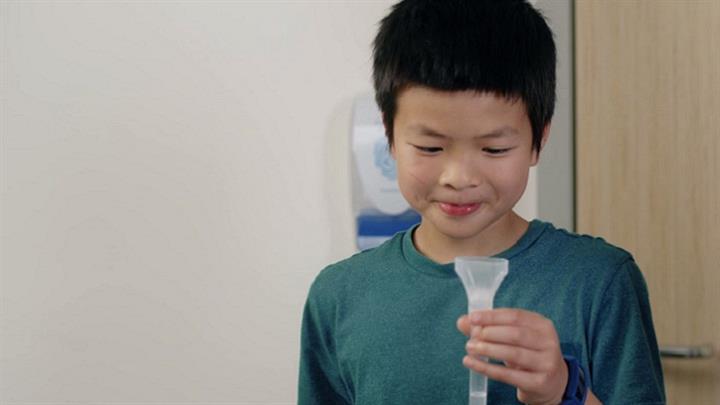 Child with mouth rinse and gargle test container