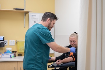 Lab worker taking blood from a patient