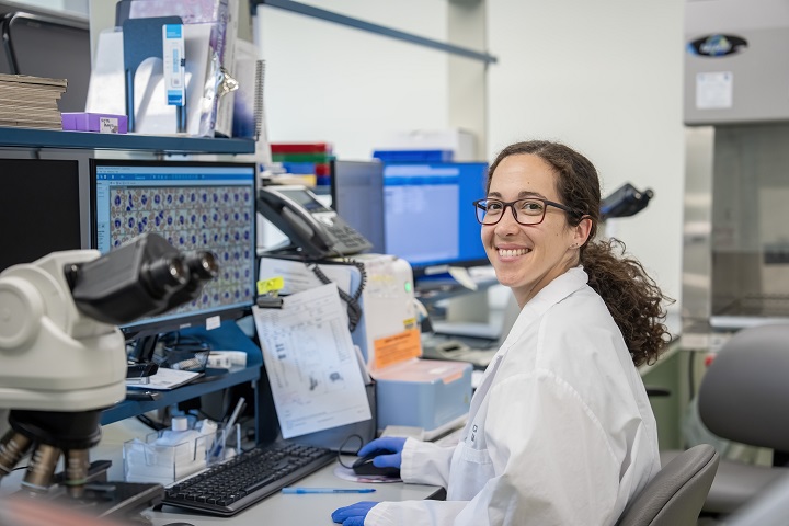 Smiling lab technician at a desk